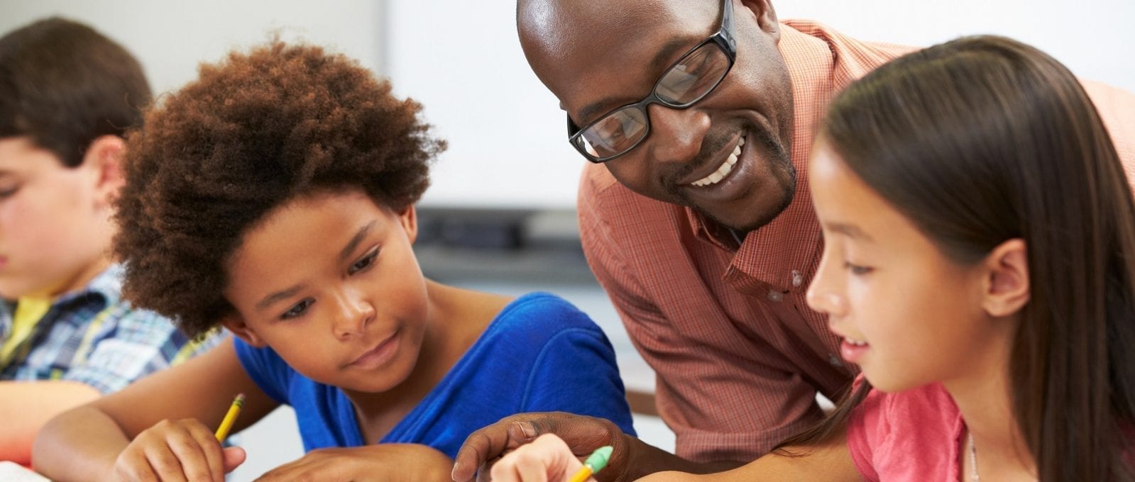 Teacher helping pupils